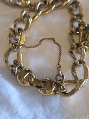 vintage Monet gold-tone charm bracelet features multiple detailed charms