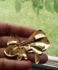 Vintage-style Bow Brooch features a polished, shiny gold-tone