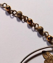 Unique Vintage 18 1/2″ Avon necklace with 2″ dangling ring with varies sized…
