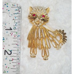 Vintage gold-tone cat brooch with red rhinestone eyes and white beaded accents