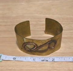 vintage mixed-metal cuff bracelet featuring S spiral design from 1950s-1970s.