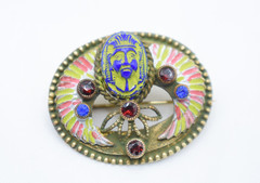 Antique Egyptian Revival winged scarab brooch featuring vibrant enamel work