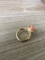 Avon vintage gold toned ring showcasing a single faux coral-colored bead.
