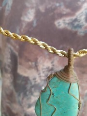 A braided red copper necklace a medium-sized, rare pear-shaped pure turquois