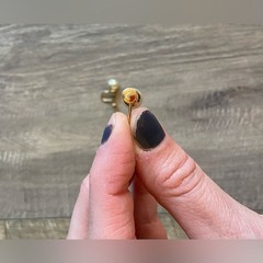 Vintage women’s stamped metal, gold color, and faux pearl earrings
