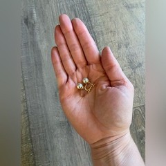 Vintage women’s stamped metal, gold color, and faux pearl earrings