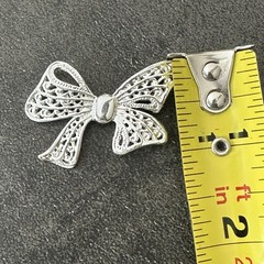 AAI Silver-tone Ribbon Bow Brooch Featuring Intricate Openwork Filigree Details.