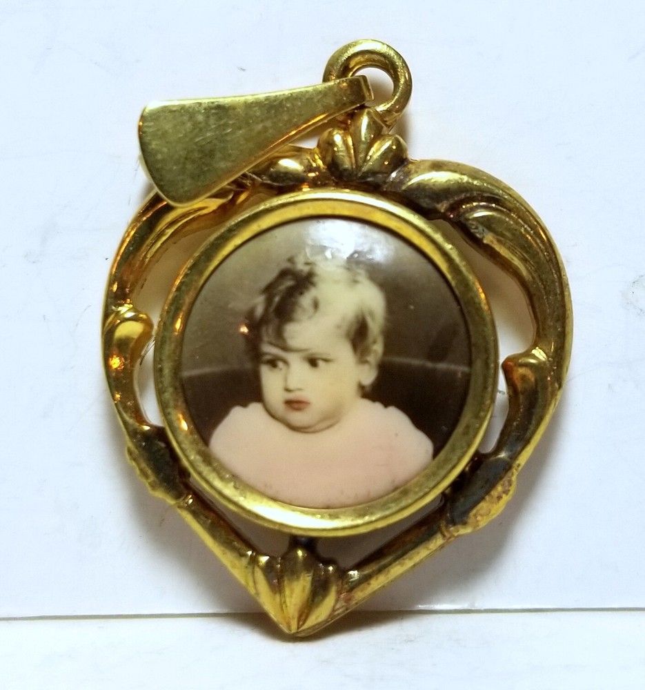 Little boy, photo heart-shaped pendant, c. 1920s, hand colored/tinted celluloid