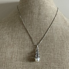 Faux pearl filigree cone necklace in silver tone metal on box chain