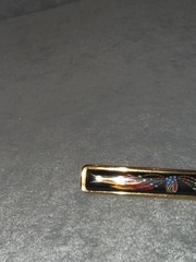 vintage Hermes enamel bar brooch featuring a vibrant red, blue, and gold JB1