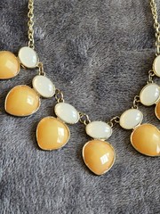 Vintage Bib necklace featuring orange and off-white acrylic stones. 21″