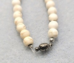 White Howlite necklace features a central turquoise bead Magnetic Clasps 15in.