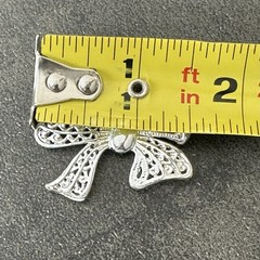 AAI Silver-tone Ribbon Bow Brooch Featuring Intricate Openwork Filigree Details.