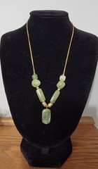 Vintage Act II necklace featuring polished green stones and a delicate gold-tone