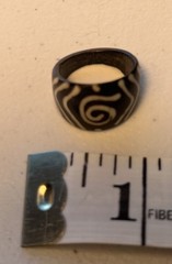 Black acrylic ring about size 3 with ivory-colored storm spiral