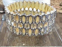 Vintage with an expandable Lucite bracelet in great condition. 1.5″ wide