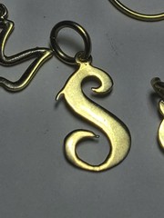5.50 14K SOLID YELLOW GOLD, 6 14K Charms and one heavy charm holder