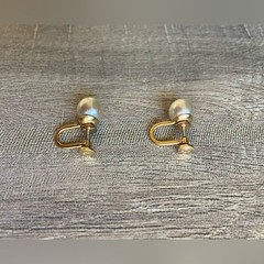 Vintage women’s stamped metal, gold color, and faux pearl earrings