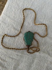 A braided red copper necklace a medium-sized, rare pear-shaped pure turquois