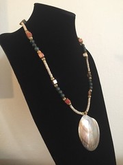 Shell Pendant on a Green, Gold, and Tan Necklace – 25.25 in.