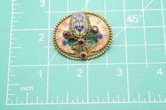 Antique Egyptian Revival winged scarab brooch featuring vibrant enamel work
