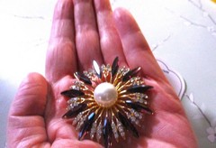 gold tone starburst brooch with purple & clear zircons + a large faux pearl