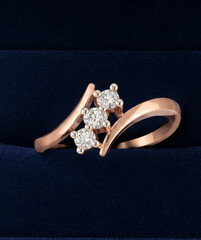 0.18TCW Round Cut White Moissanite Trilogy Swirl Design Ring In 10K Rose Gold FN