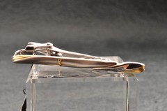 Near mint, gold and Cufflinks and silver tie clip, “Yves Saint Laurent”, case.