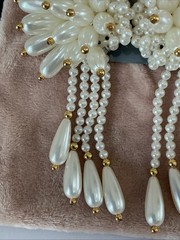 vintage-style earrings feature a cluster of white faux pearls and gold beads