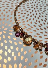 Vtg Cookie Lee faceted Purples/Yellows Lucite Charm Necklace on pale Gold chain