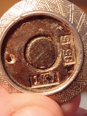 vintage 8545 charm.It is designed as a round textured metal meant to