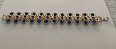Vintage Gold Tone multi-gemstone link bracelet with a fold-over clasp 7’ in