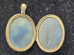 Antique gold tone oval locket with etched intricate script monogram and bail