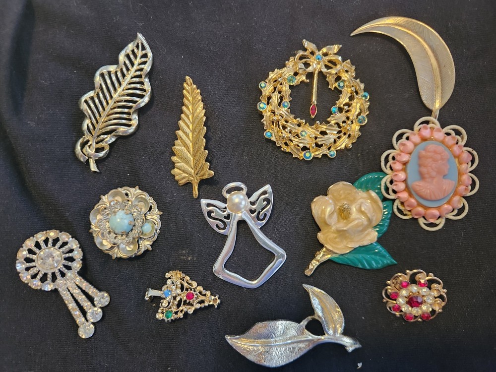 12 vintage Brooches. 1.5 inches – 3 inches big.