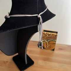 Vintage-style beaded necklace with a square, metal pendant paired with earrings