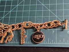 Vintage Jackie Collins Gold Tone Enamel Lady Boss Charm Bracelet Toggle Clasp