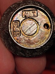 vintage 8545 charm.It is designed as a round textured metal meant to