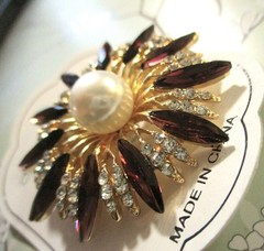 gold tone starburst brooch with purple & clear zircons + a large faux pearl