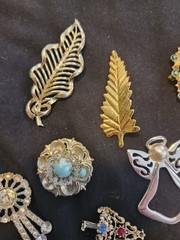 12 vintage Brooches. 1.5 inches – 3 inches big.