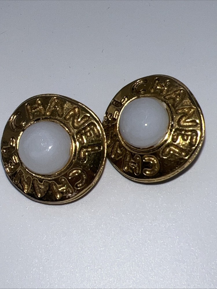 Vintage CHANEL golden round shape faux pearl earrings with cutout logo. Clip On
