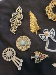 12 vintage Brooches. 1.5 inches – 3 inches big.
