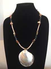Shell Pendant on a Green, Gold, and Tan Necklace – 25.25 in.