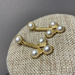Pierced faux pearl cabochon dangle earrings in gold tone metal