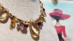 Vtg Cookie Lee faceted Purples/Yellows Lucite Charm Necklace on pale Gold chain