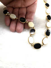 Vtg gold tone chain strung black cream 2 sided Necklace
