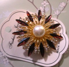 gold tone starburst brooch with purple & clear zircons + a large faux pearl