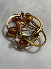 Vintage gold tone brooch with amber colored stones