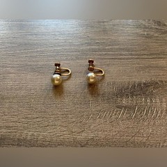 Vintage women’s stamped metal, gold color, and faux pearl earrings