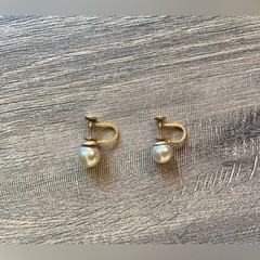 Vintage women’s stamped metal, gold color, and faux pearl earrings