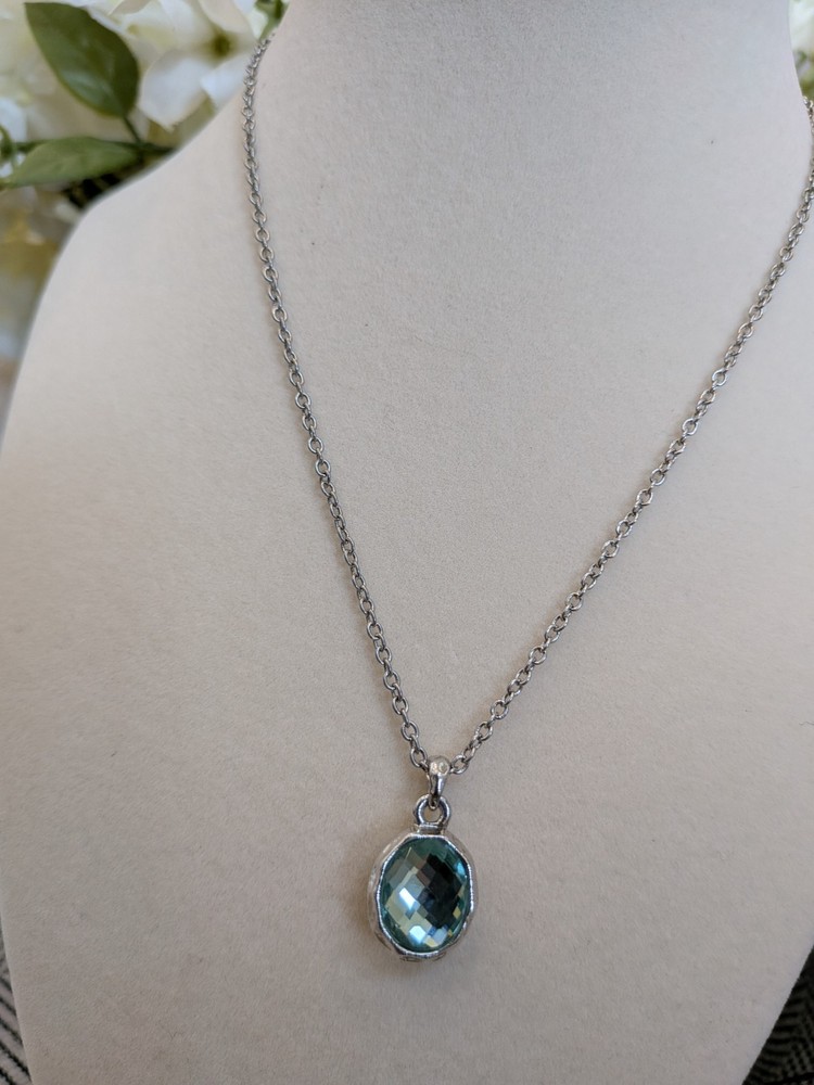 vintage Cookie Lee silver necklace with a faceted aqua blue crystal pendant.